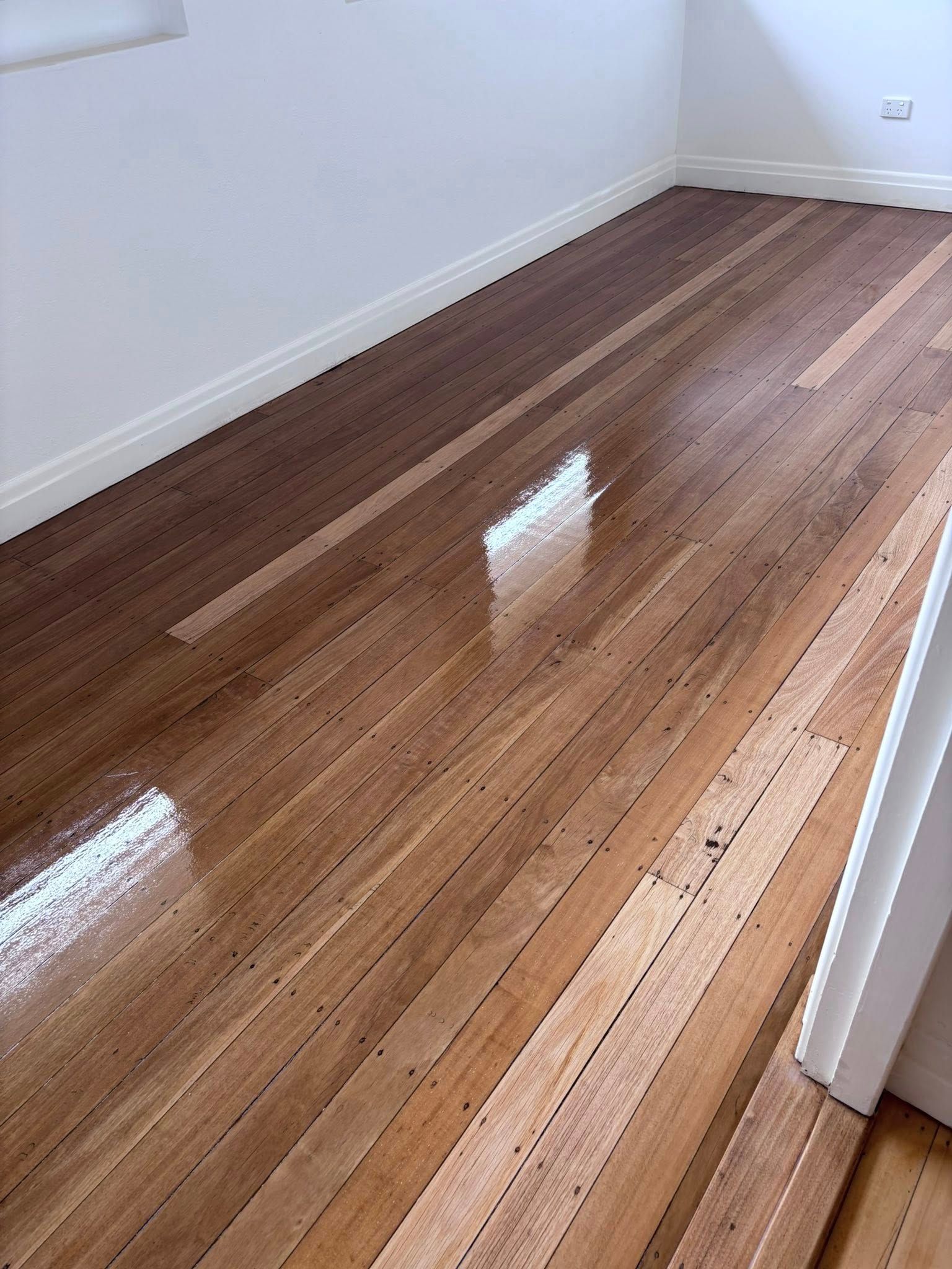 Polished, Reddish-brown Wooden Floor — Scott Johnston Floor Sanding in Bentley Park QLD