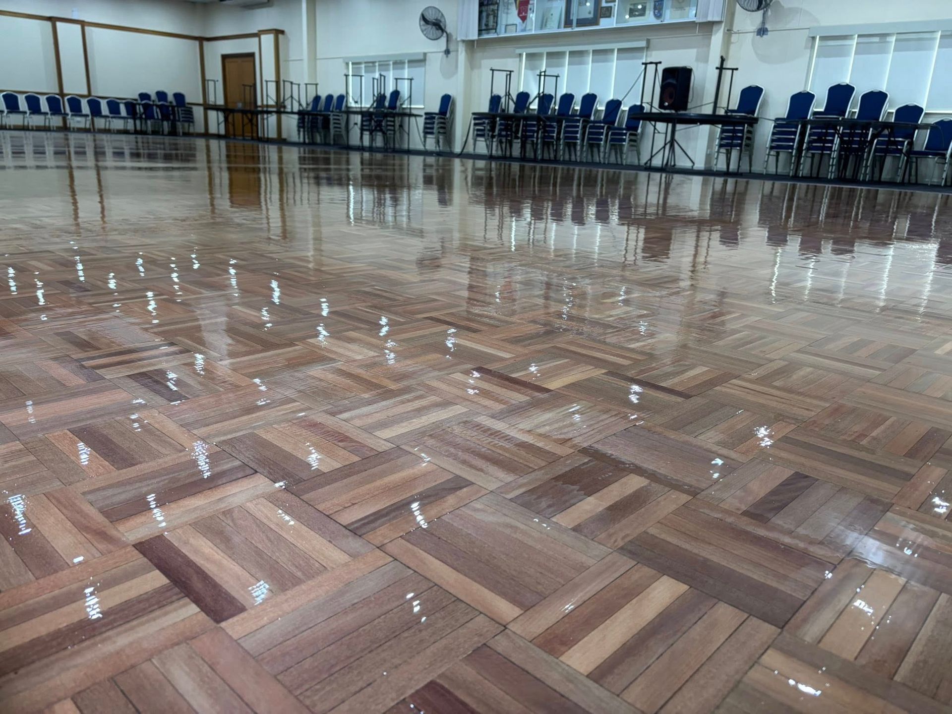 Shiny, Reddish-brown Hardwood Floor Reflecting Light and the Window — Scott Johnston Floor Sanding in Bentley Park QLD