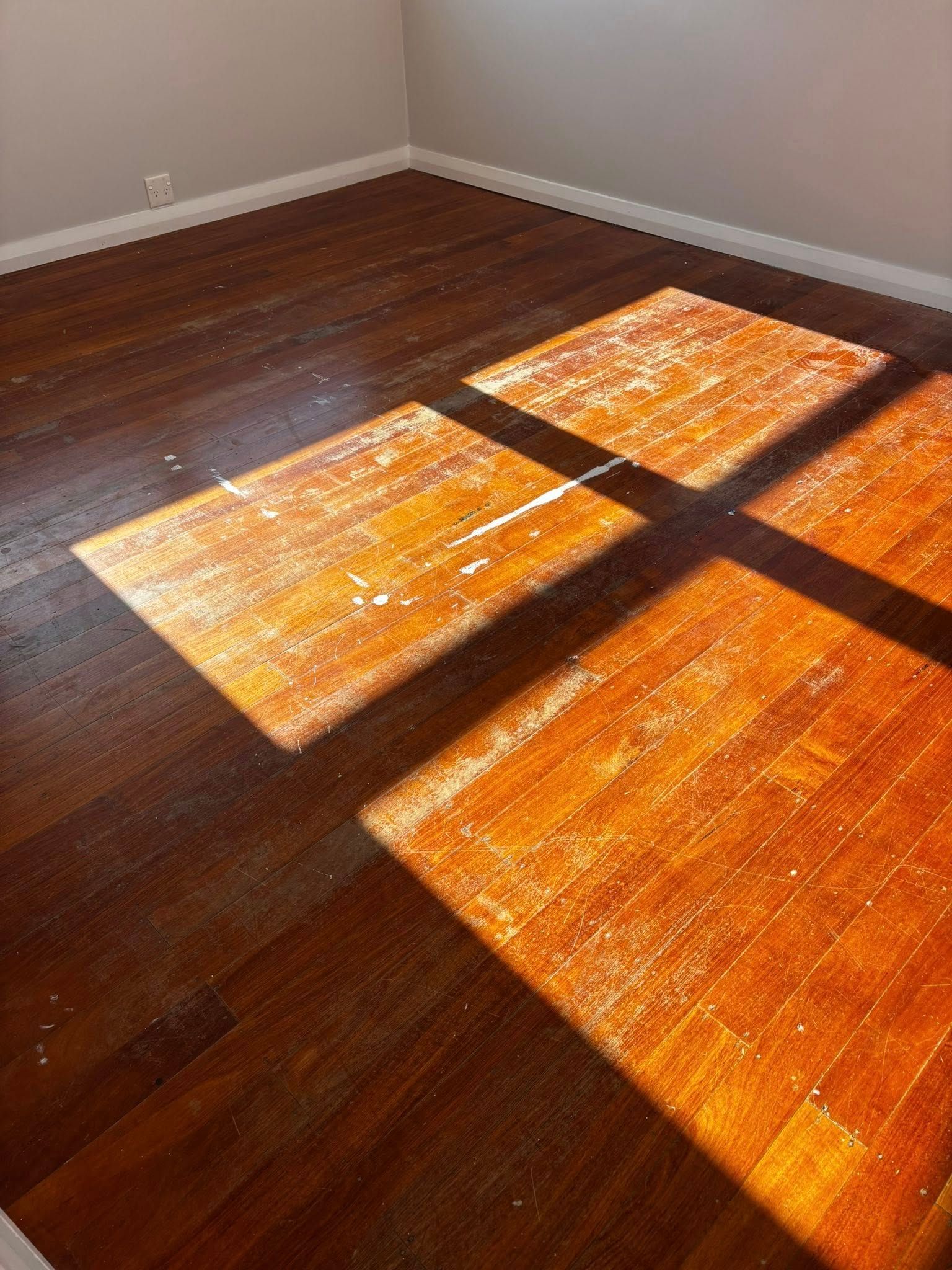 Wooden Floor With Alternating Light and Dark Wood Planks — Scott Johnston Floor Sanding in Bentley Park QLD