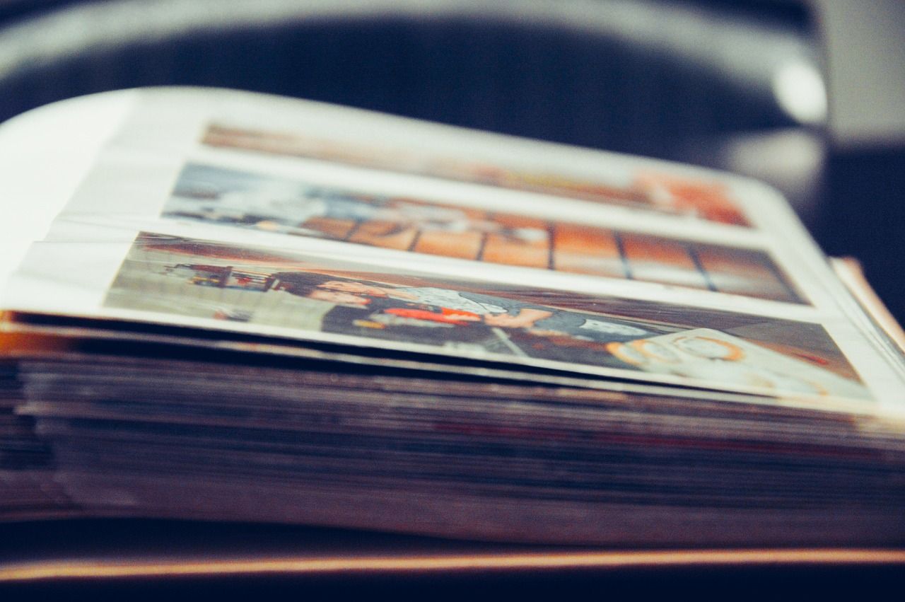 Photo of a photo album, showing 3 photos on a page