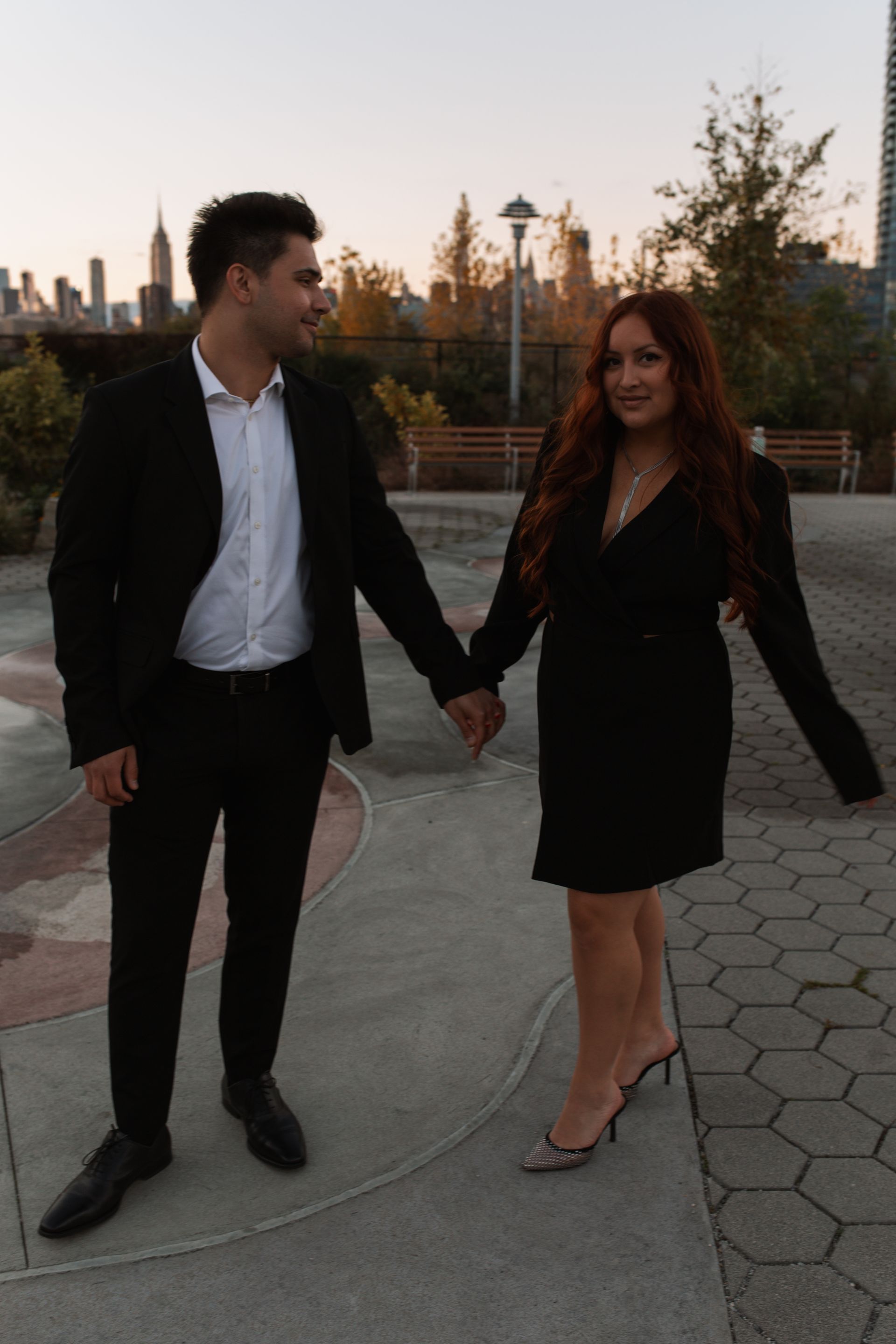 A man and a woman are holding hands in a park