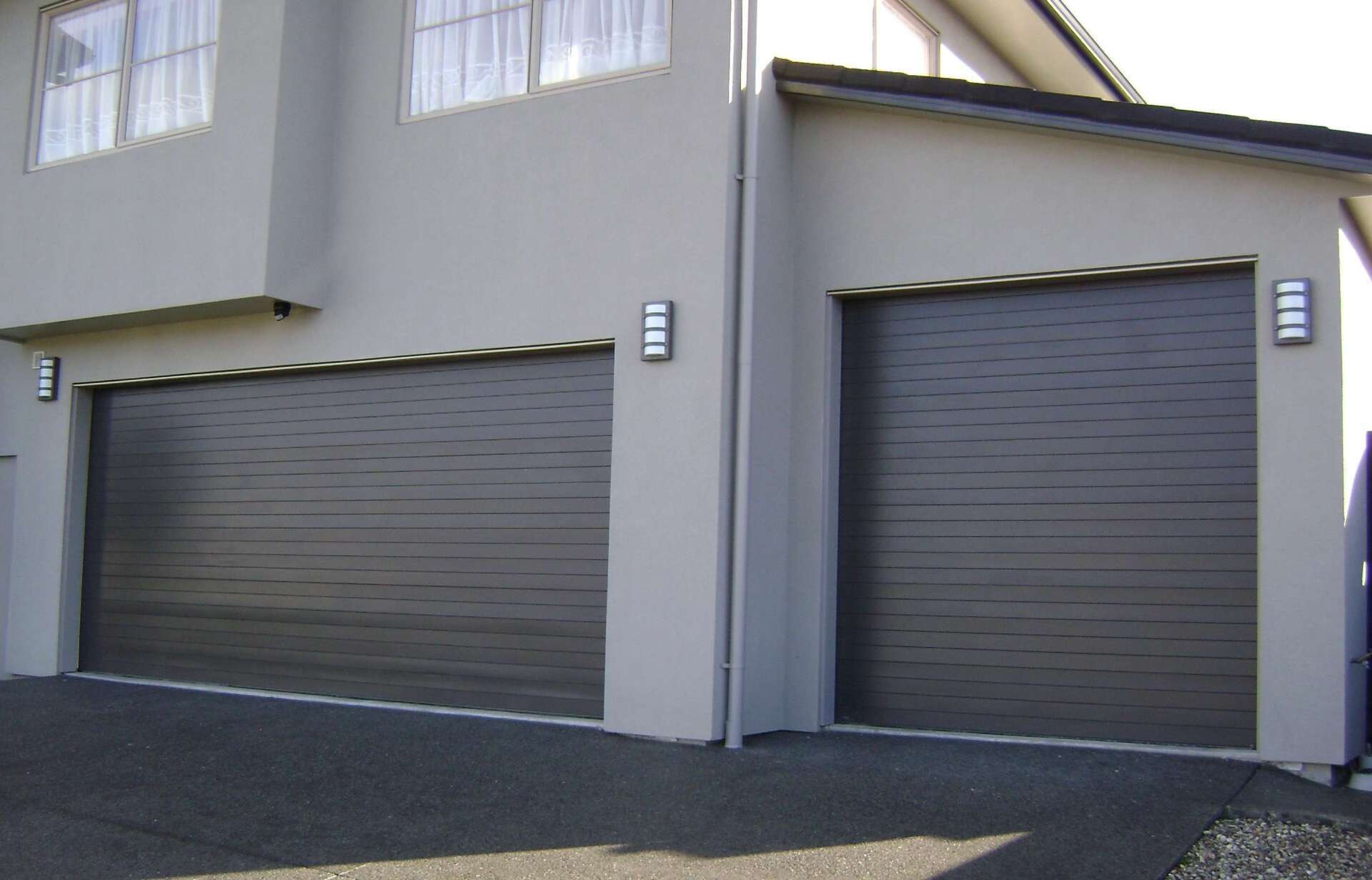 Two garage doors on the side of a house