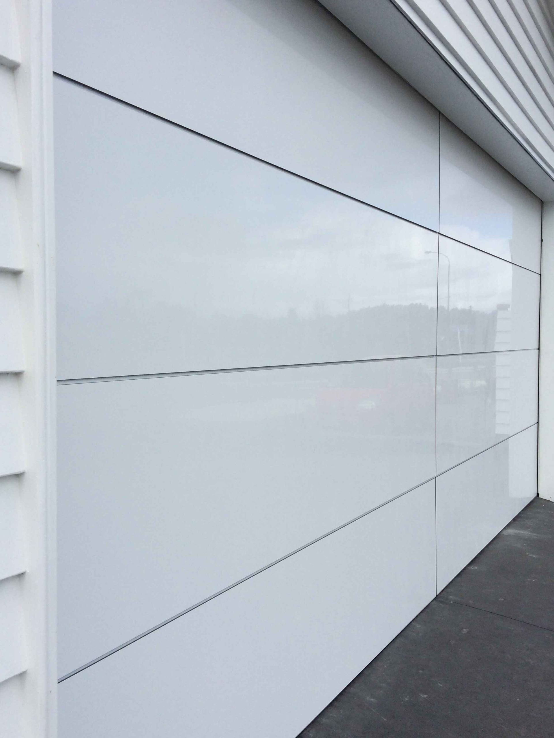 A white garage door with black stripes on it