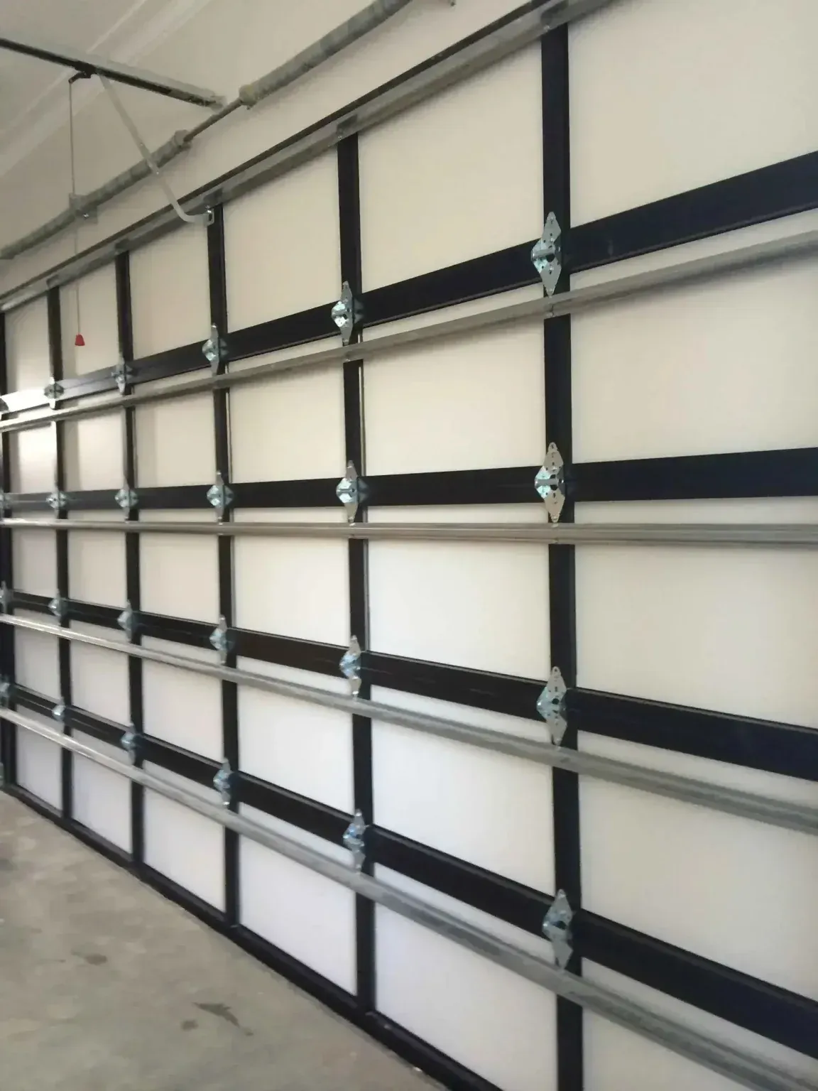 A garage door with black stripes and white panels
