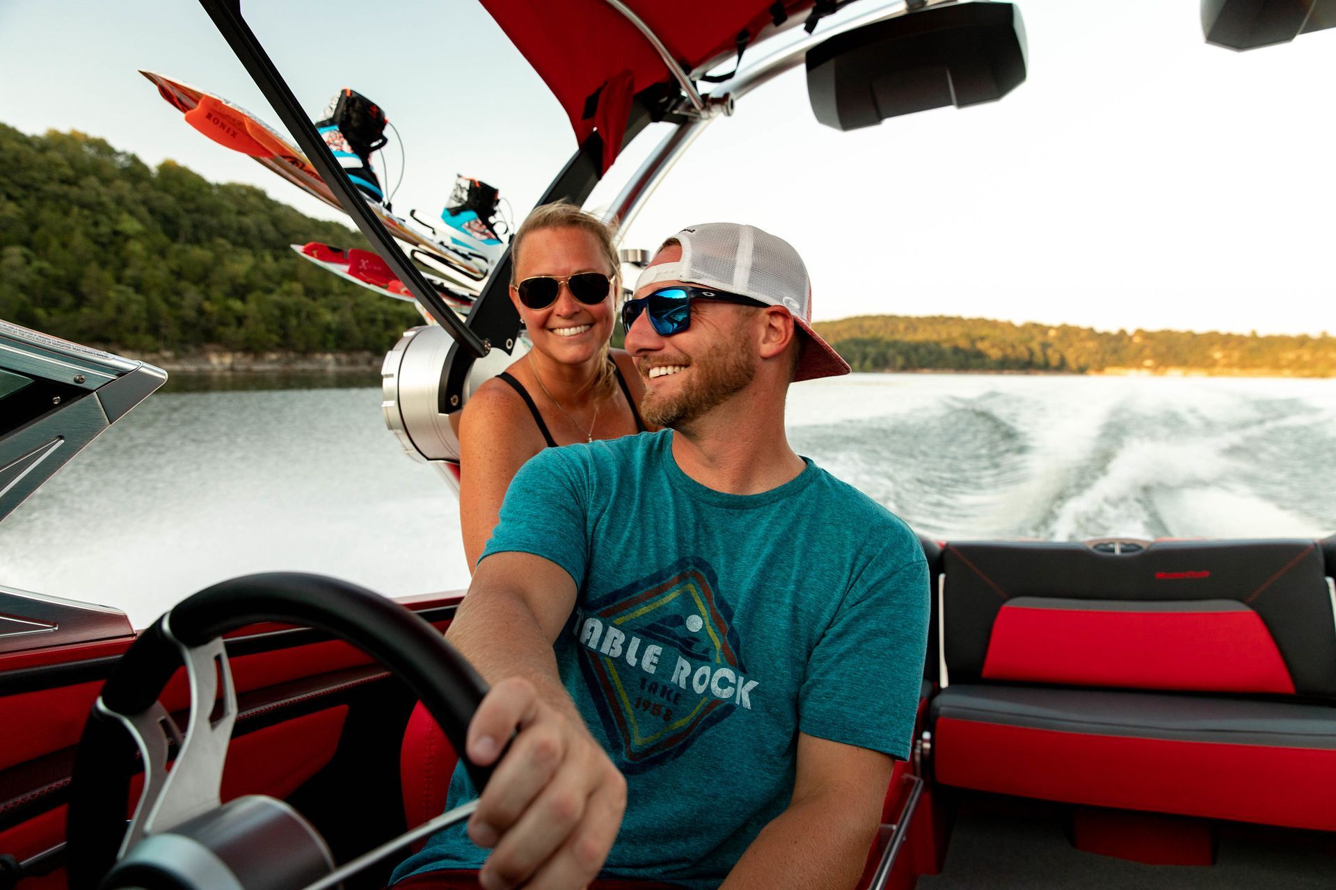 A man and a woman are sitting in a boat on a lake.