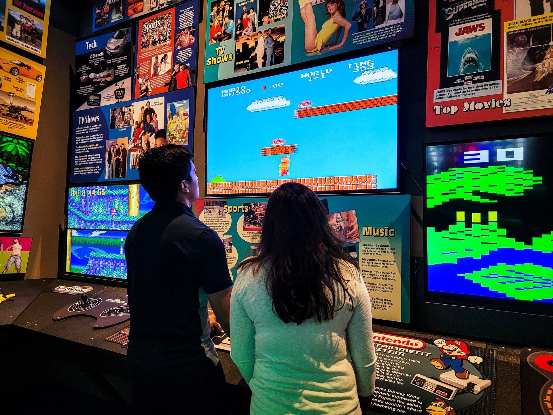 A man and a woman are playing a video game.