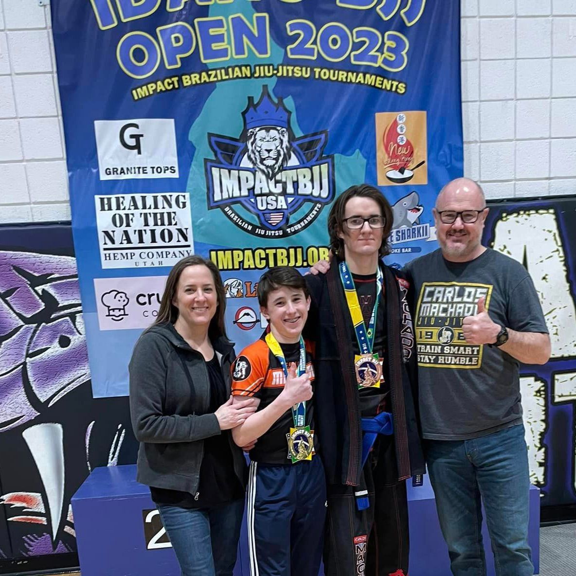A group of people standing in front of a sign that says open 2023