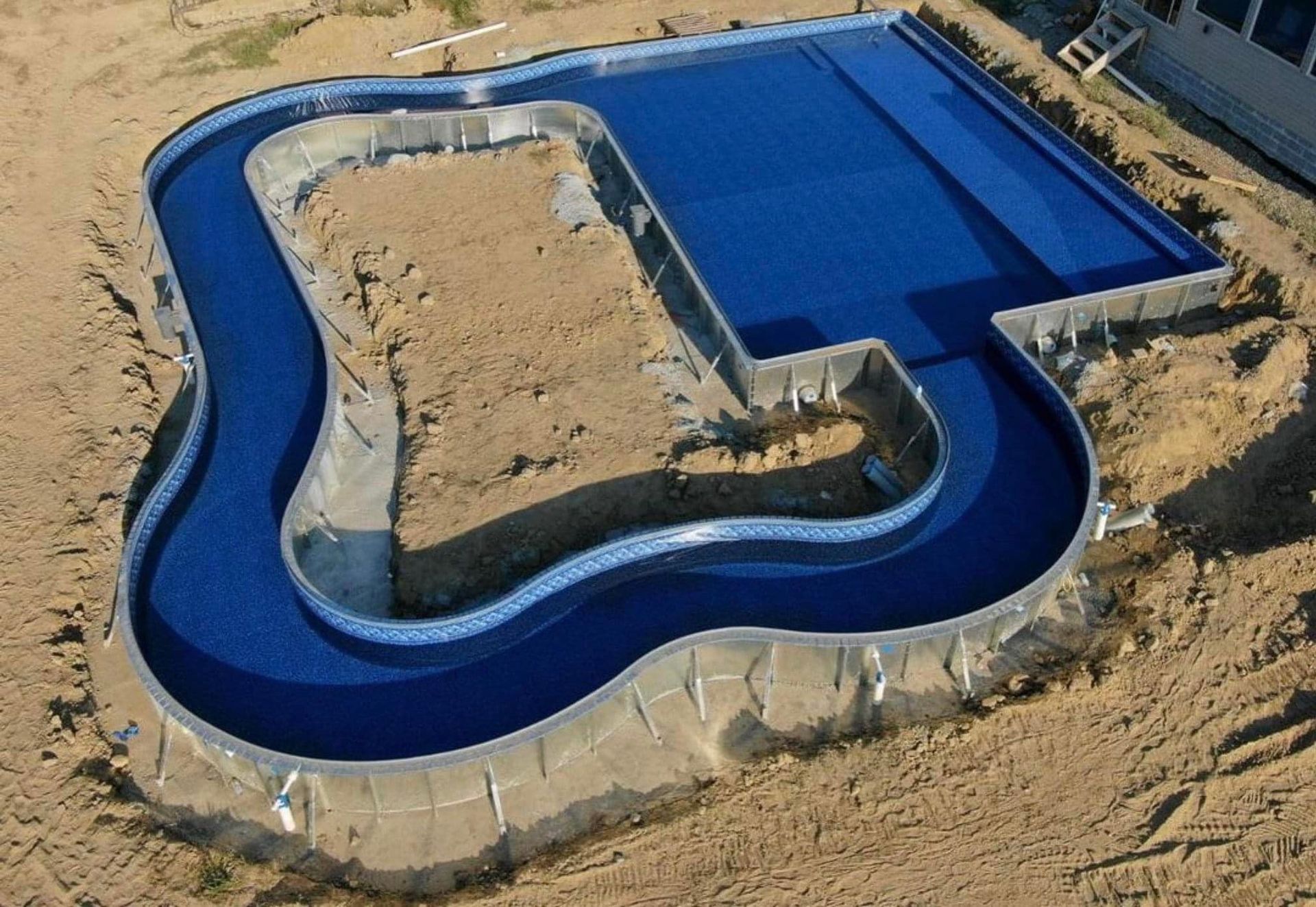 An aerial view of a swimming pool under construction