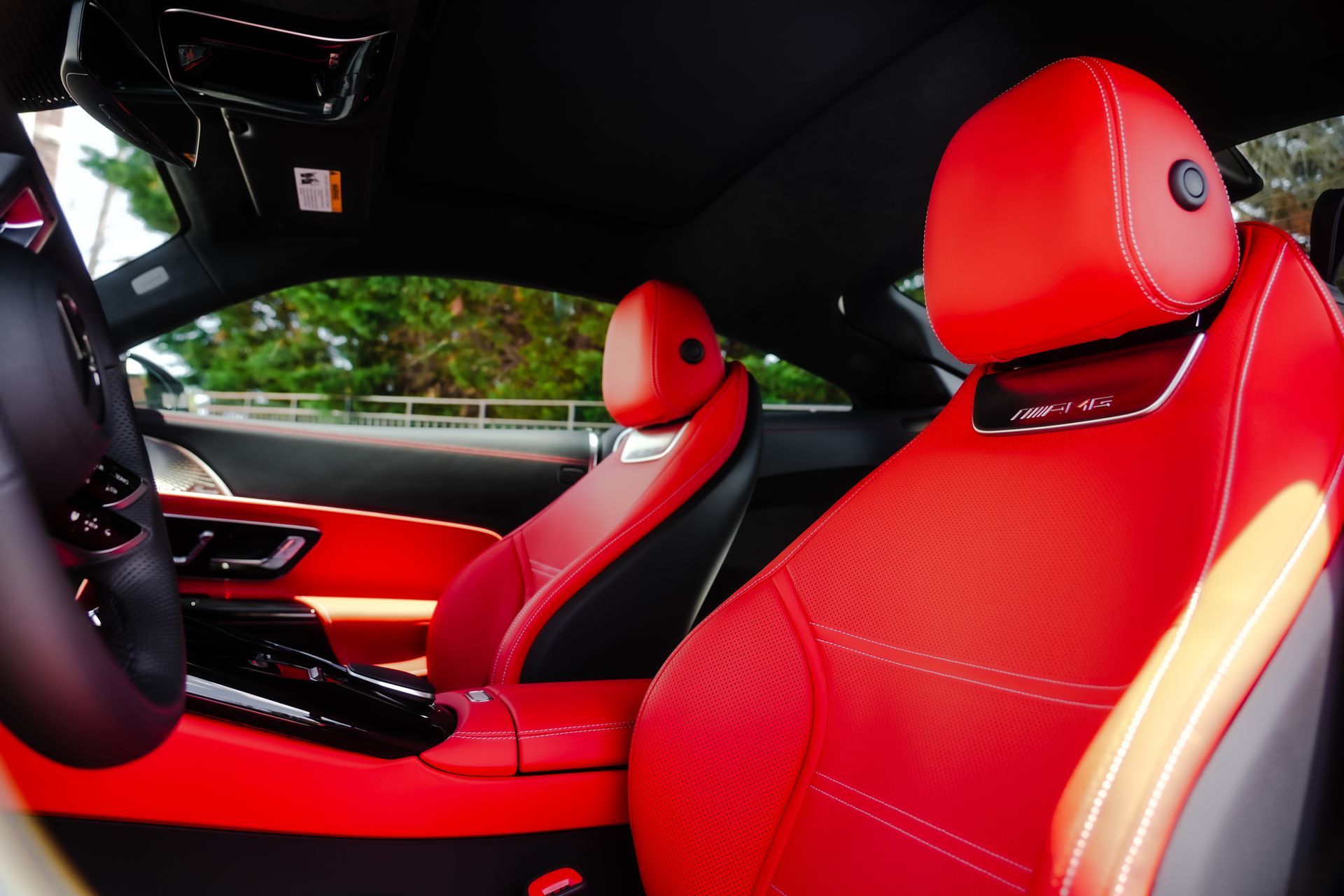 Red leather interior of a car, including seats, dashboard, and steering wheel.