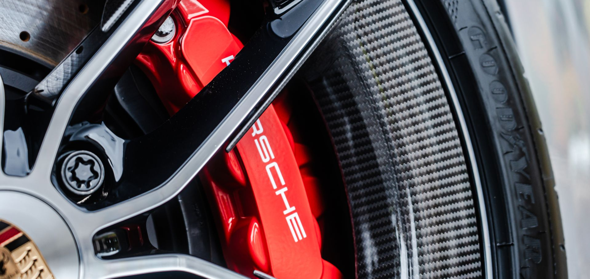 Close-up of a red Porsche brake caliper with the name