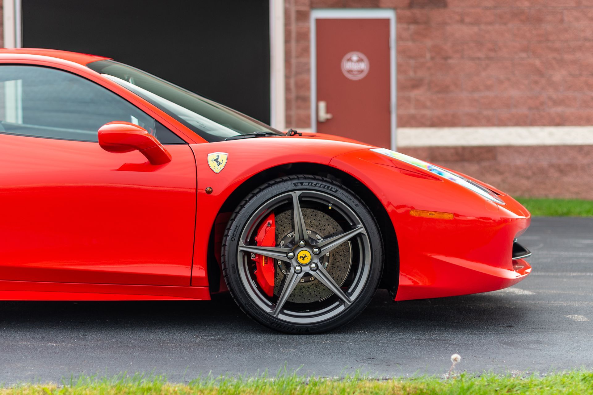 Red Ferrari sports car parked outdoors.
