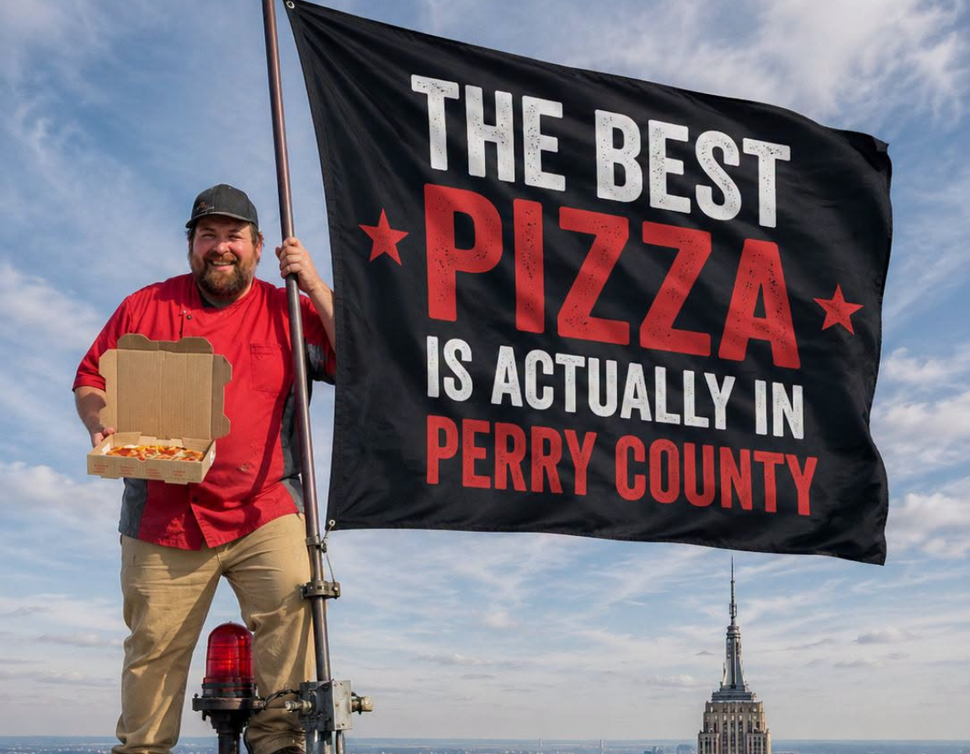 Perry Pizza Co. team member hand-stretching pizza dough in front of a wood-fired oven.