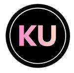 A black circle with a thin white border containing the pink letters 