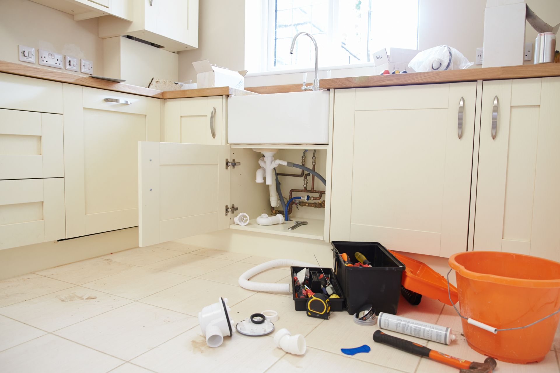 Kitchen cabinet open showing under sink