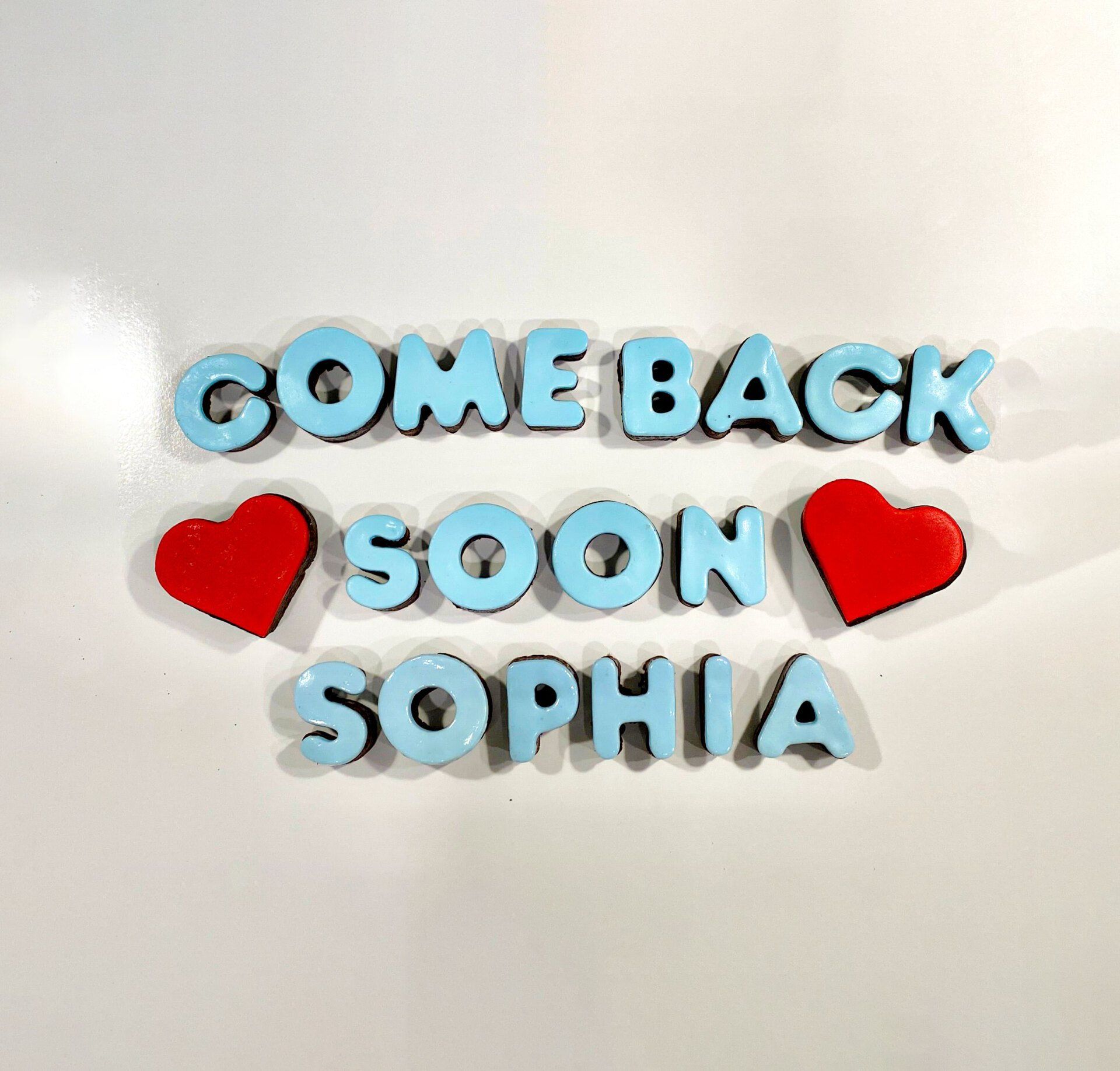 A sign that says come back soon sophia on it