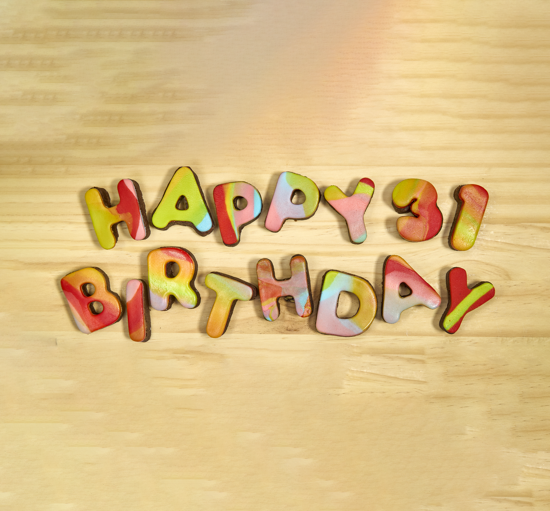A wooden table with the words happy 31 birthday on it