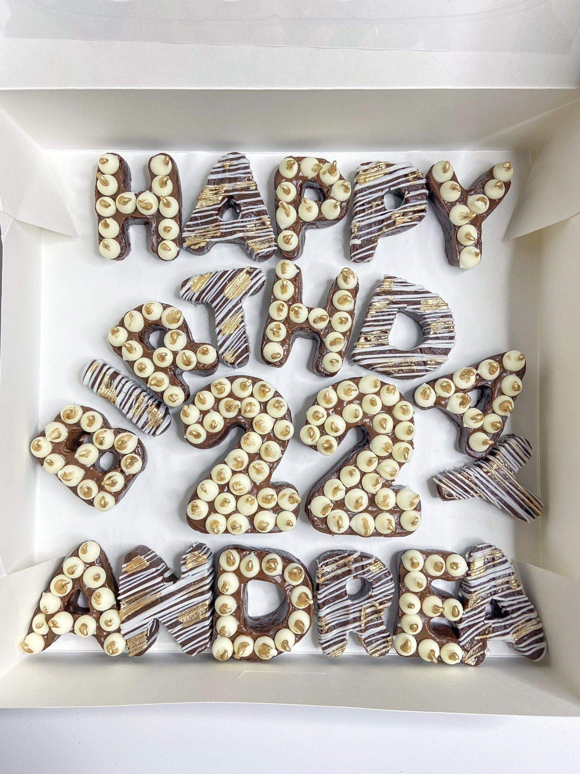 A box of chocolate covered letters that say happy birthday andrea