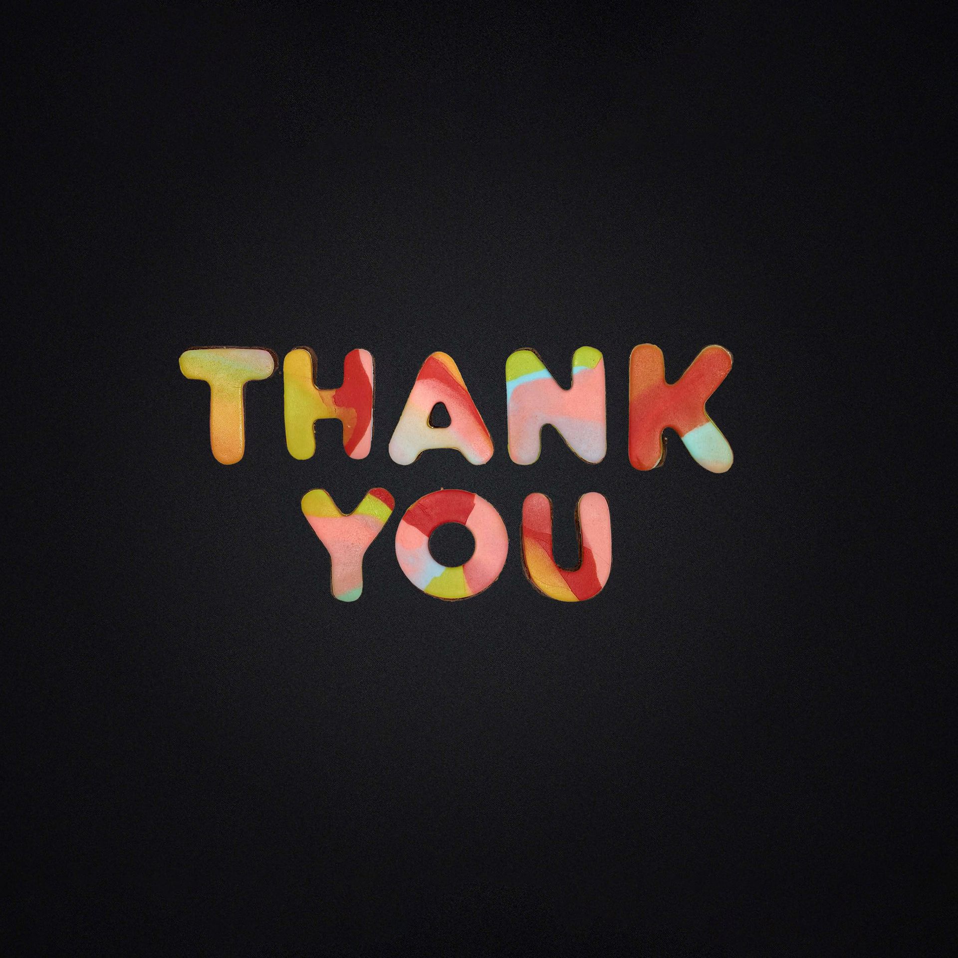 The word thank you is written in colorful letters on a black background