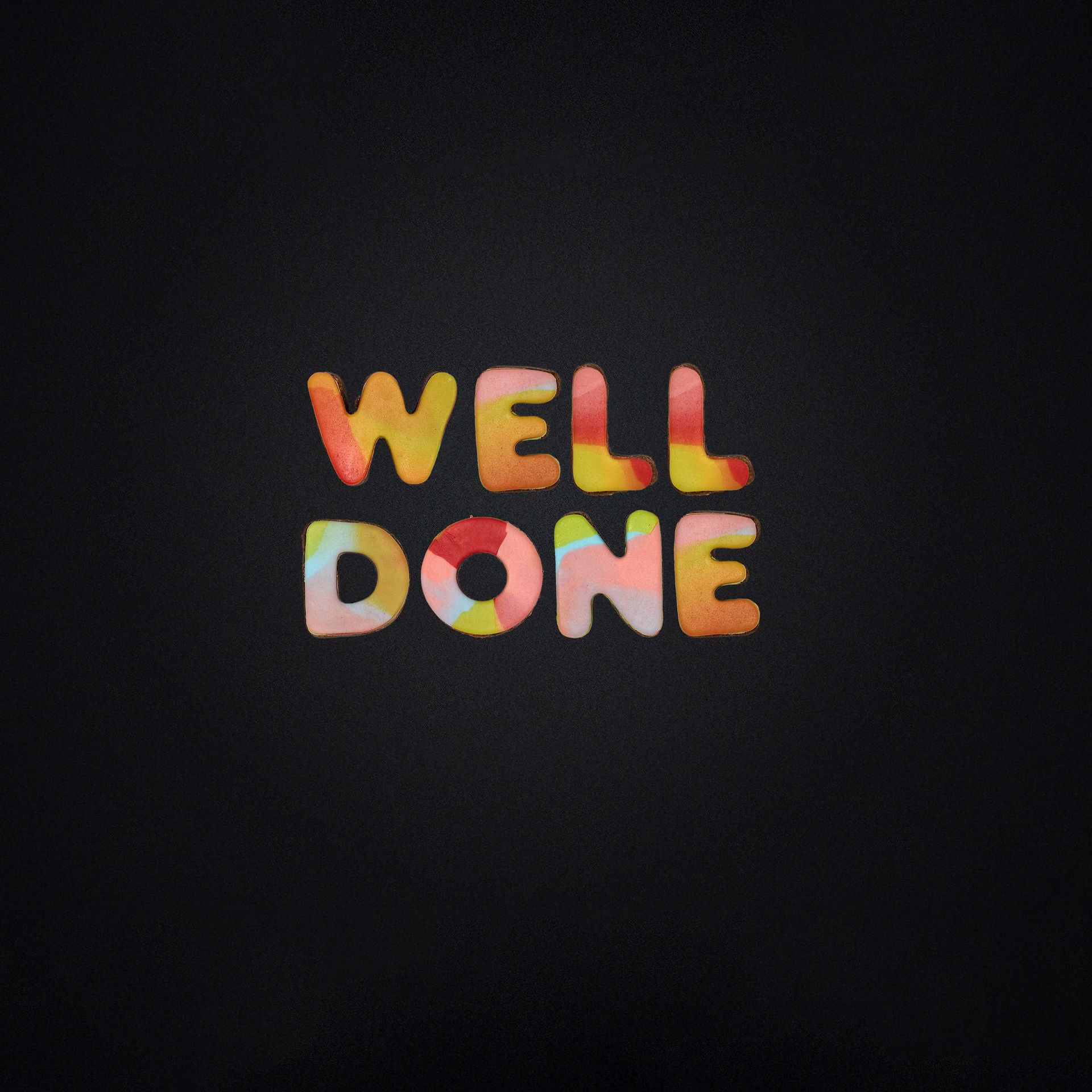 The word well done is written in colorful letters on a black background