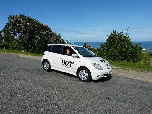 A white car with the number 007 on the side of it