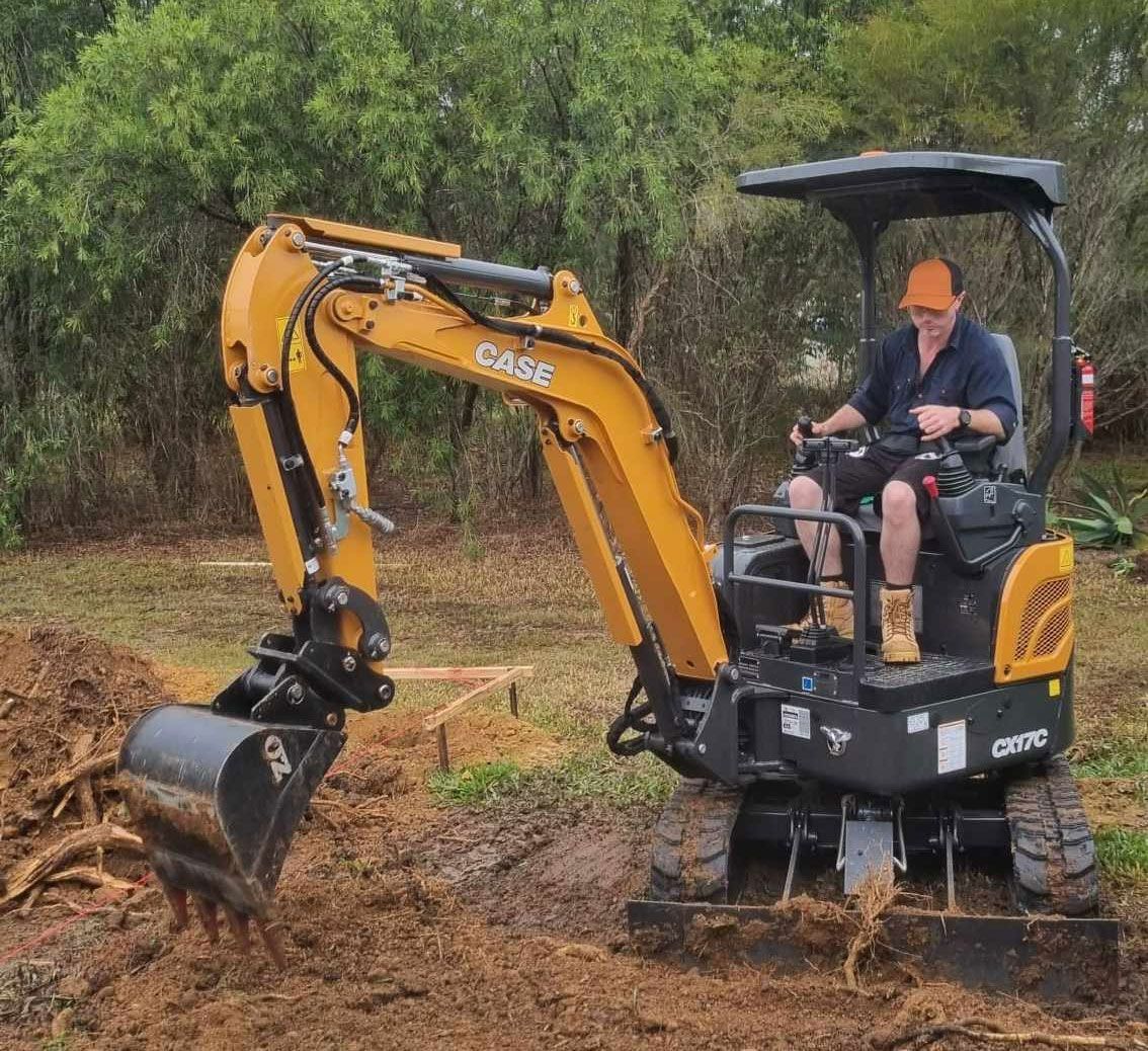 Diesel Mechanic Operating A Mini Excavator