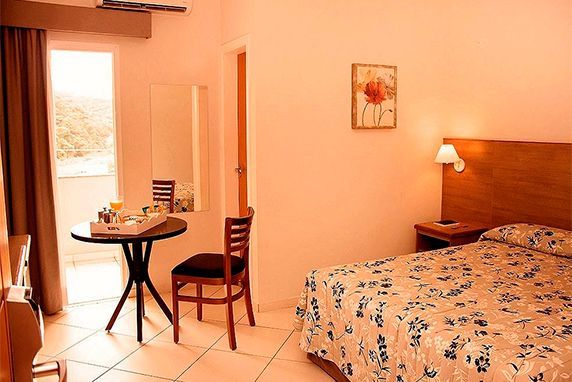 quarto com cama de casal, mesa e cadeira 
