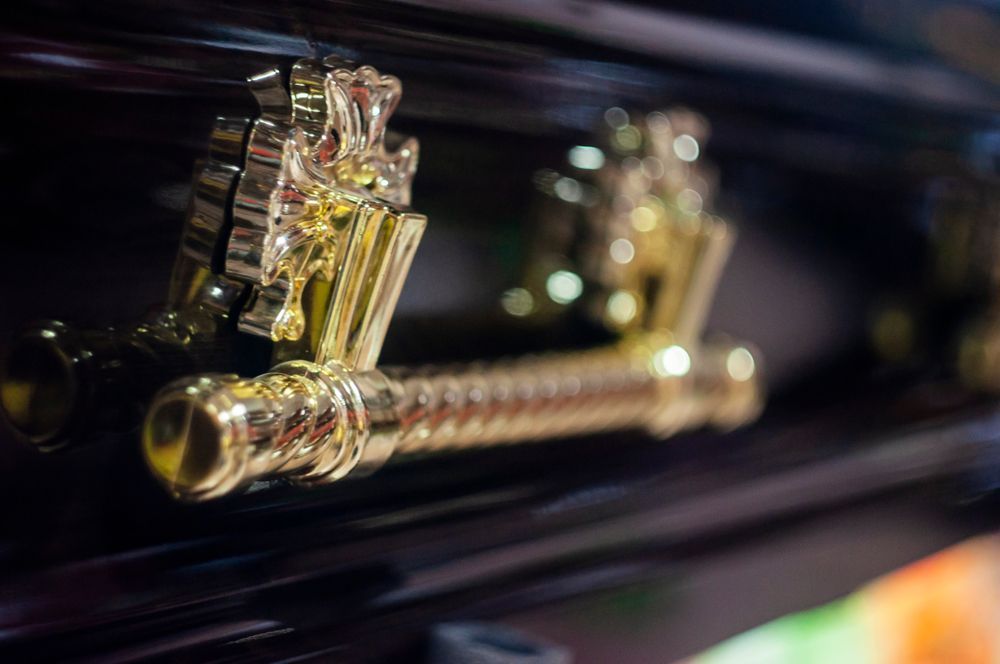 A Close Up Of A Gold Handle On A Coffin — Territory Funerals In Yarrawonga, NT