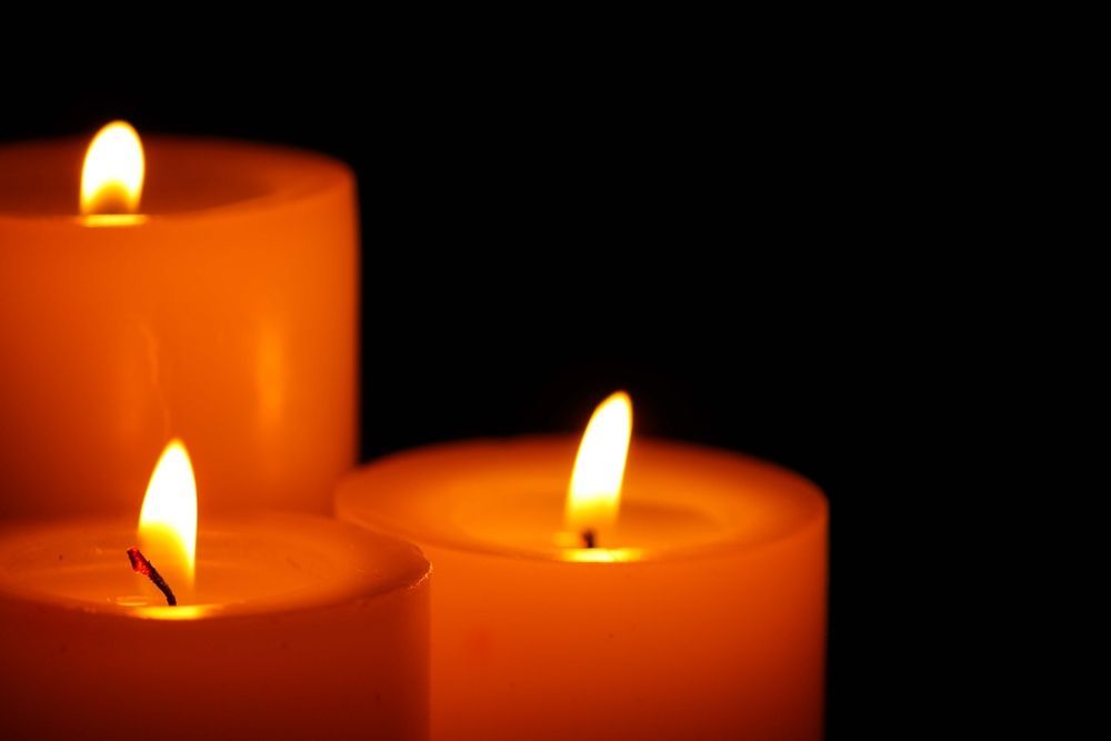 Three Candles Are Lit Up In The Dark On A Black Background — Territory Funerals In Zuccoli, NT