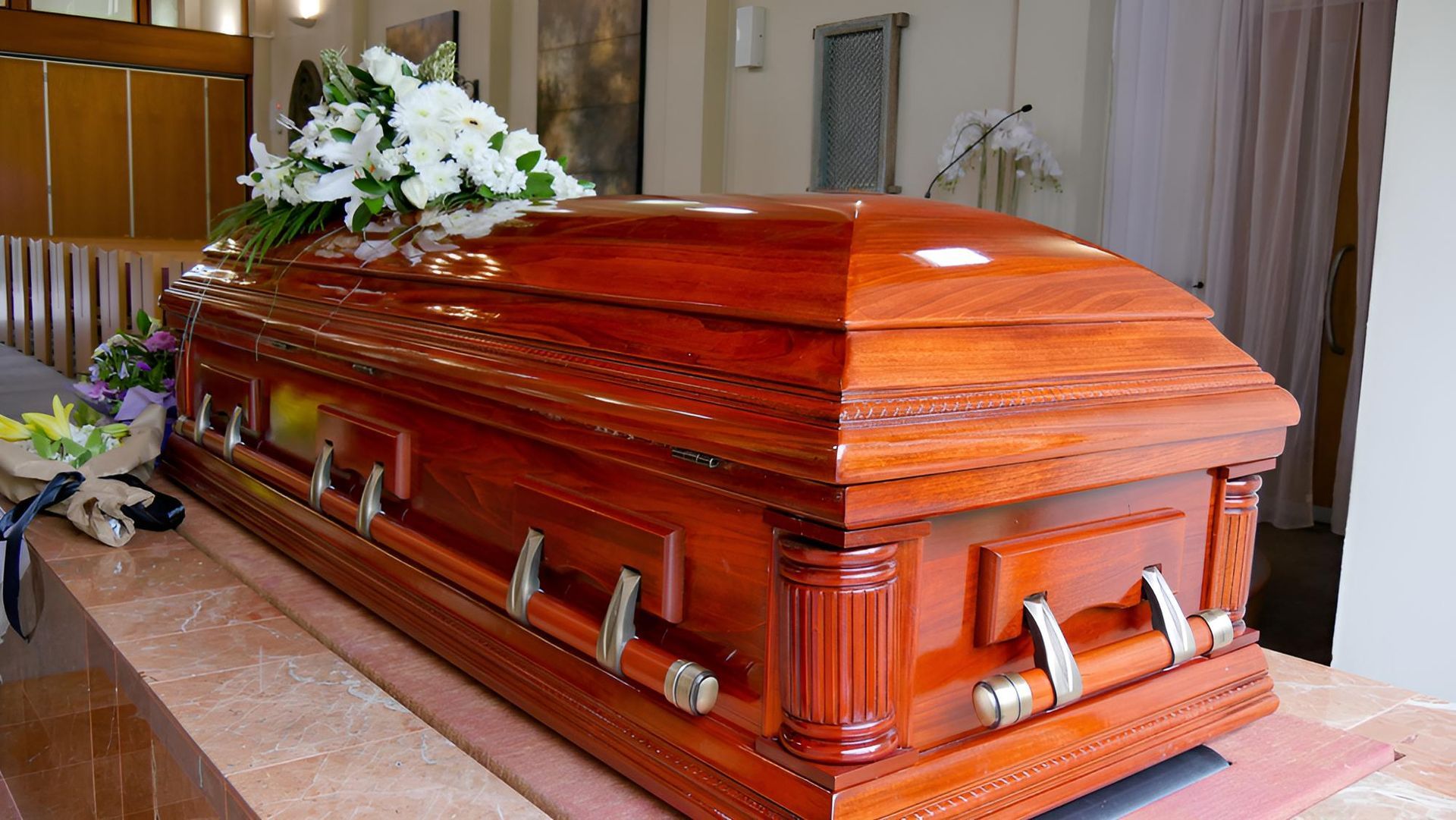 A Coffin with White Flowers — Territory Funerals In Yarrawonga, NT