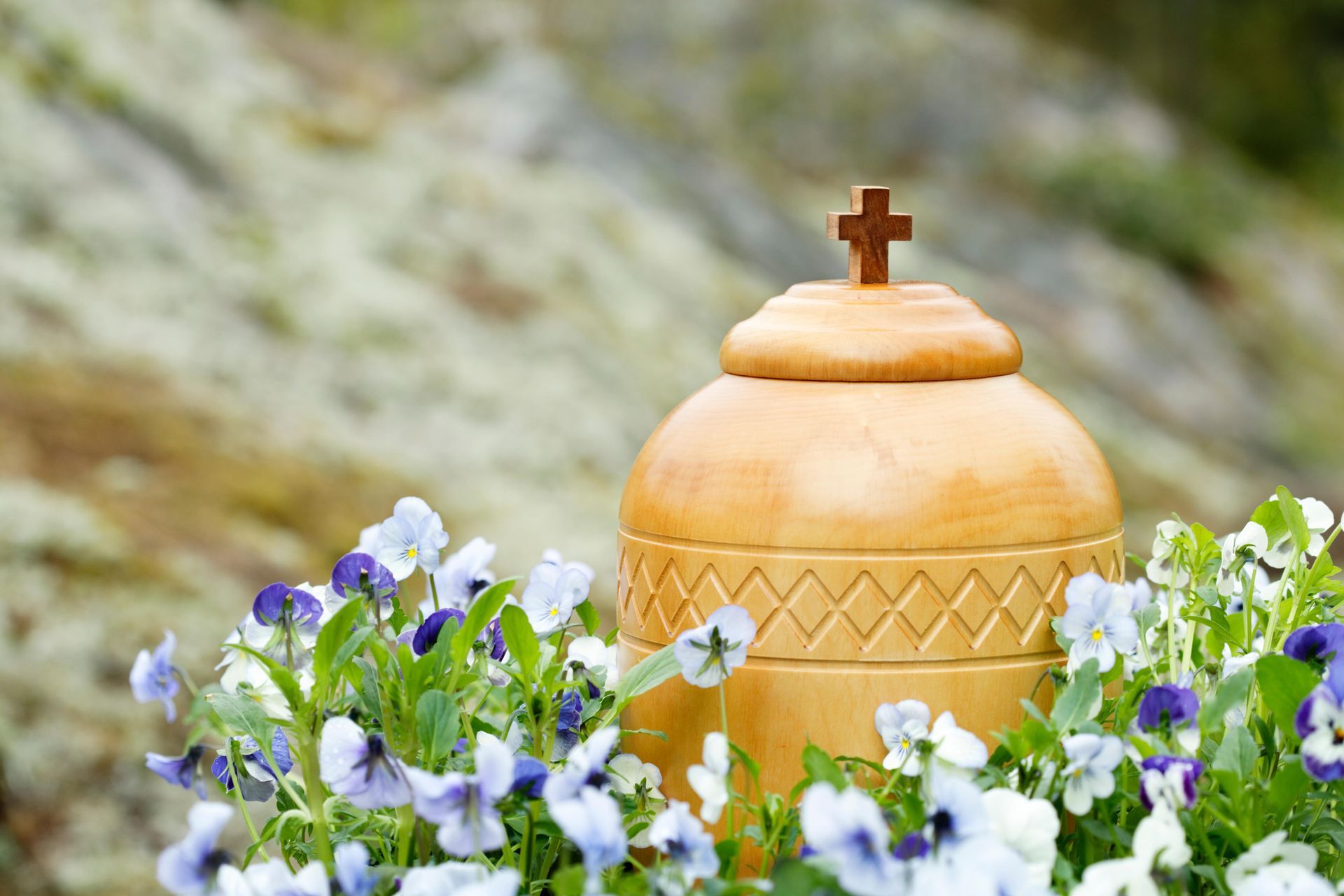 A Yellow Urn Surrounded By White Flowers — Territory Funerals In Yarrawonga, NT