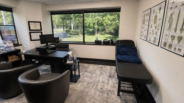 True North Medical Care exam room in Edina with patient seating, medical charts, and an examination table