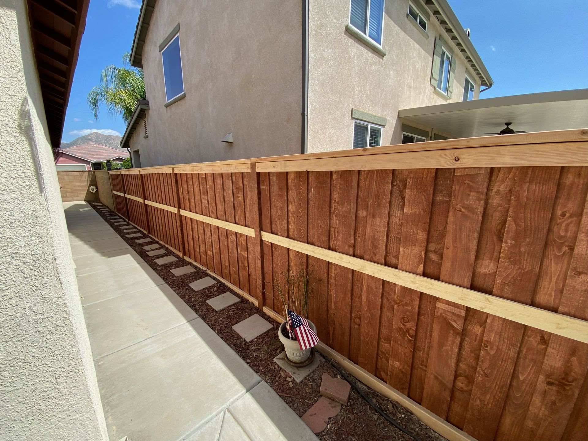 A wooden fence is sitting next to a house.