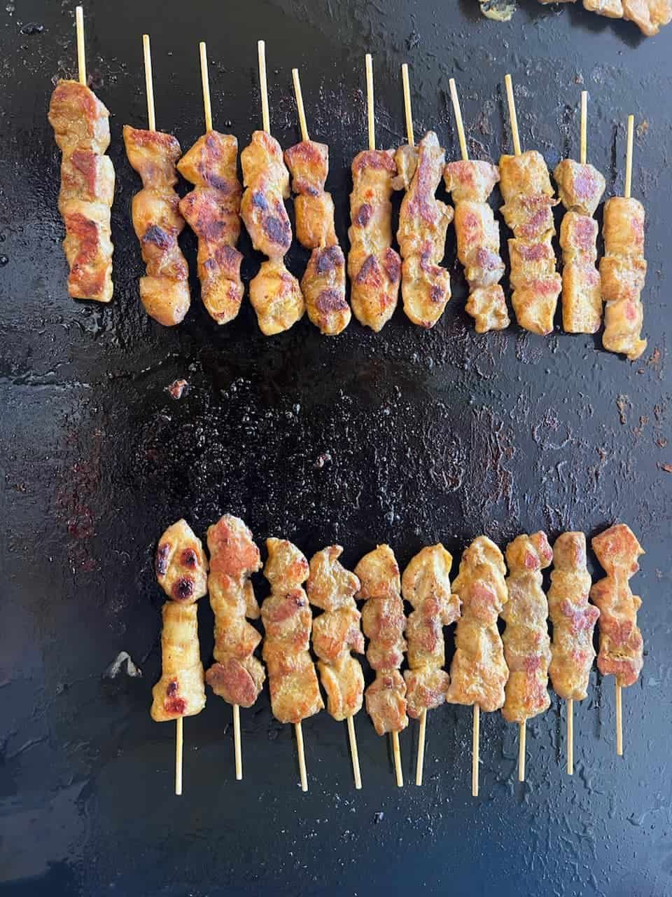 Several Skewers of Meat Are Cooking on a Grill — Thai Satay Hut In Lismore, NSW