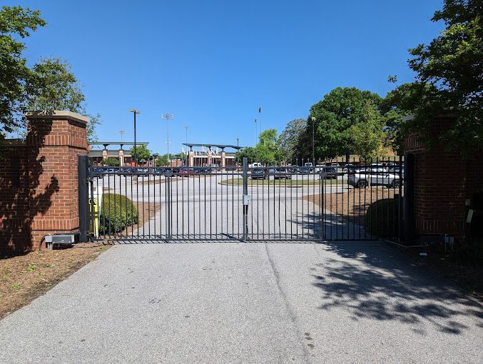 A gate that is open to a parking lot
