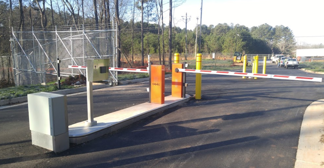 A parking lot with a barrier on the side of the road.