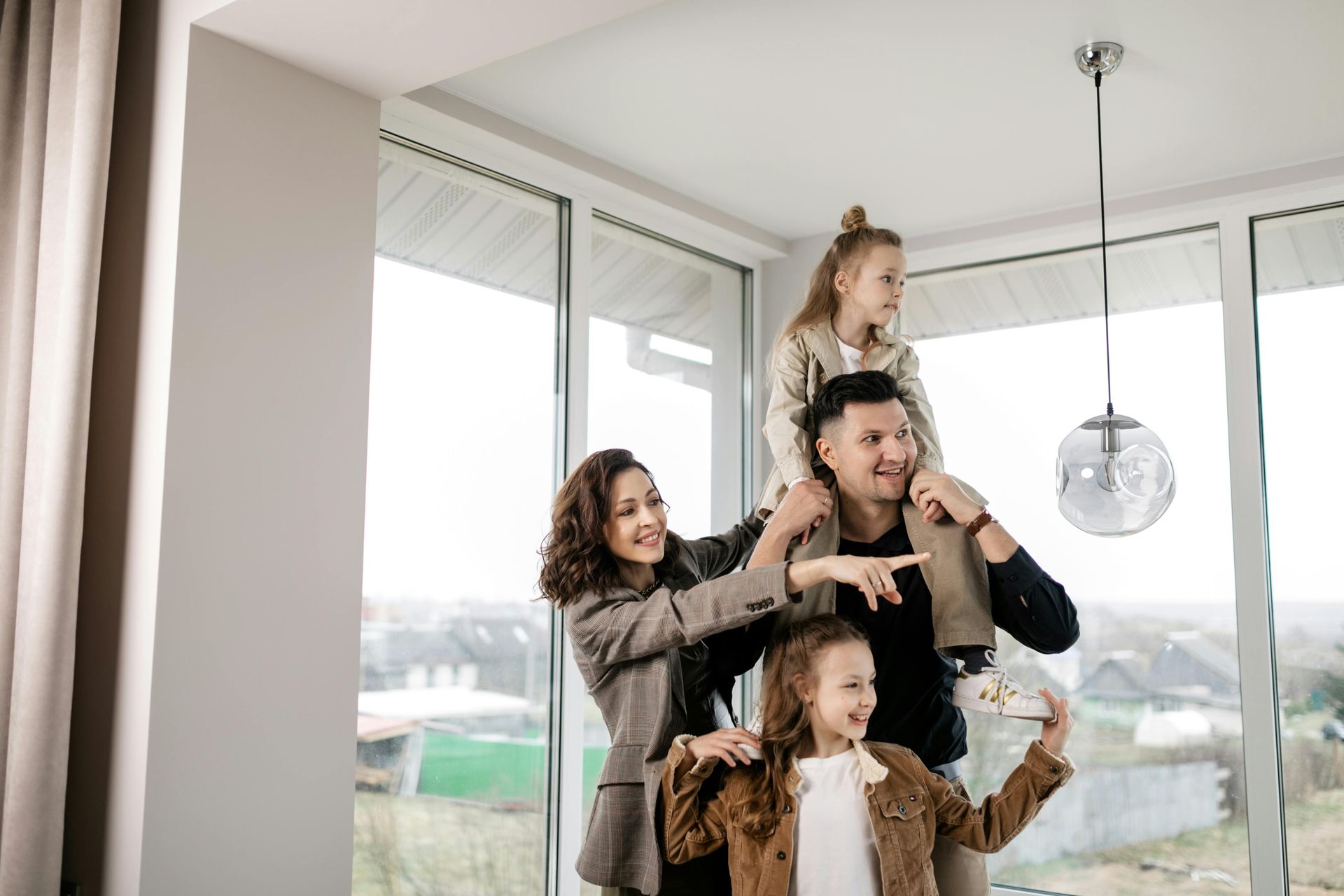 A family is taking a picture of themselves in their new home.