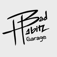 A logo with the words "Bad Habitz" in stylized white text and "Garage" below, set against a dark background.