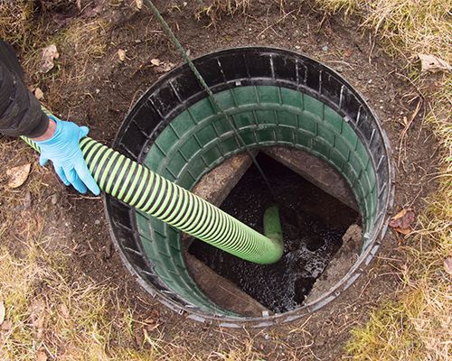 Hose Pumping Out Home Septic Tank — Brentwood, CA — Williams Sanitary Service, Inc. Hose Pumping Out Home Septic Tank — Brentwood, CA — Williams Sanitary Service, Inc.