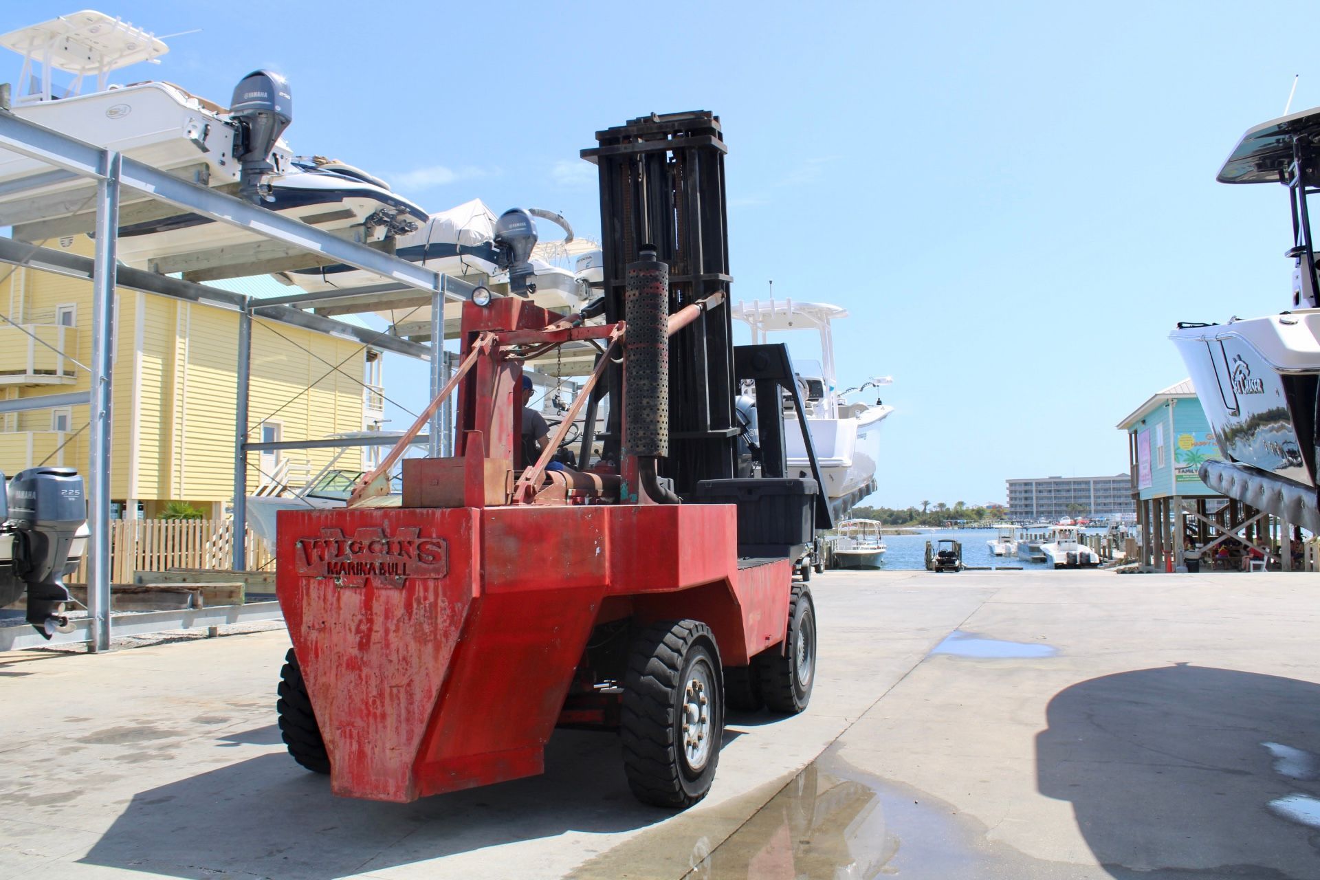A red forklift used for lifting boats at our boat storage facility.
