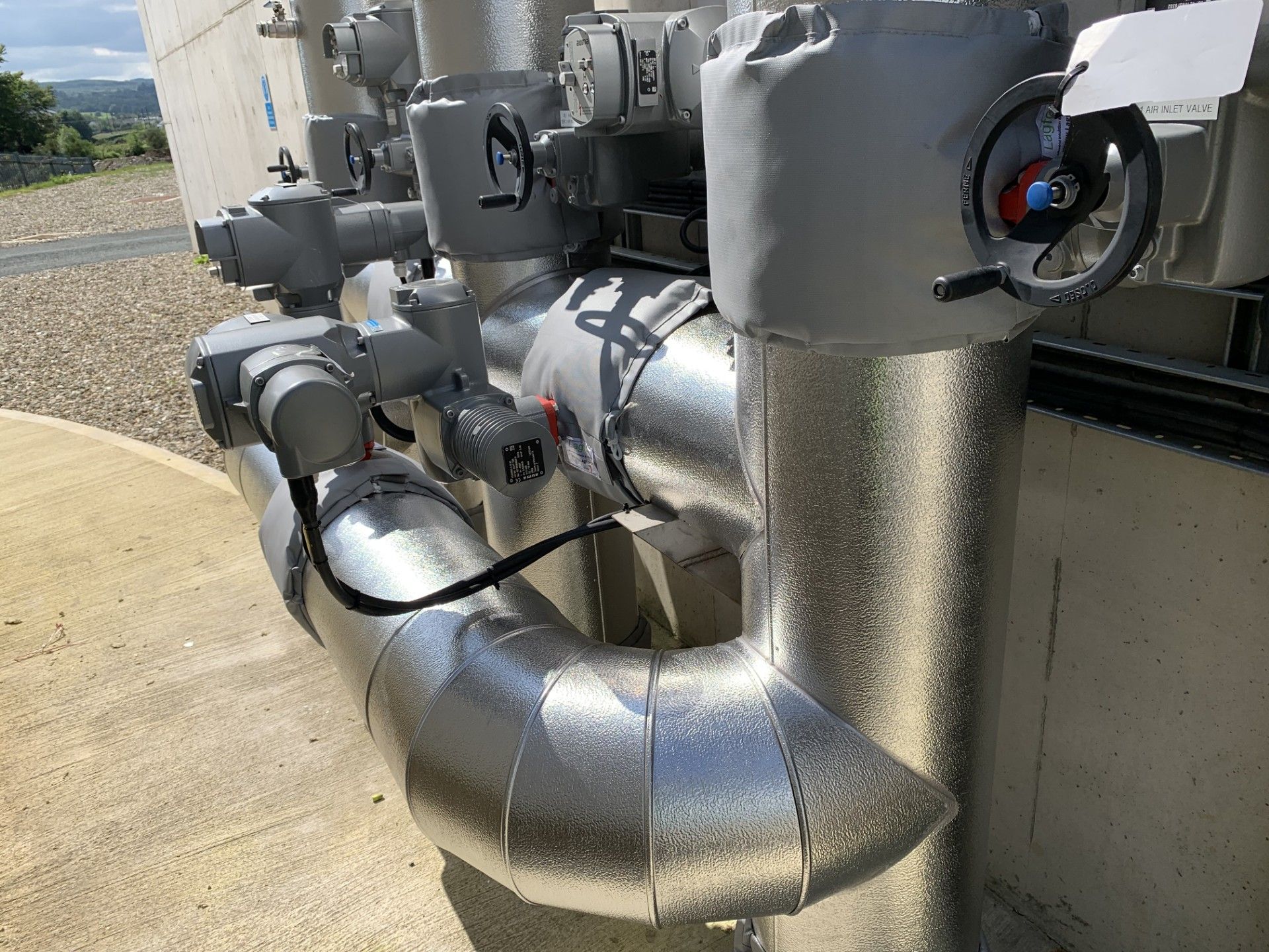 Pipework insulated with fiberglass rockwool sections and clad with aluminium in a waste water treatment facility in Donegal