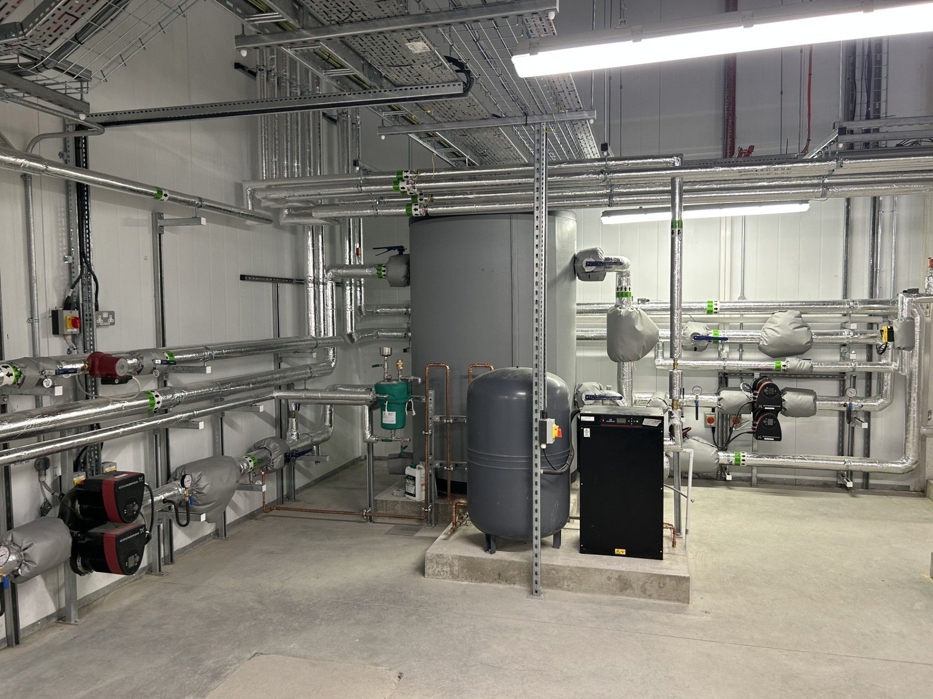 Boiler house water services pipework insulated with foiled fiberglass by Lagforce in Nass in Kildare
