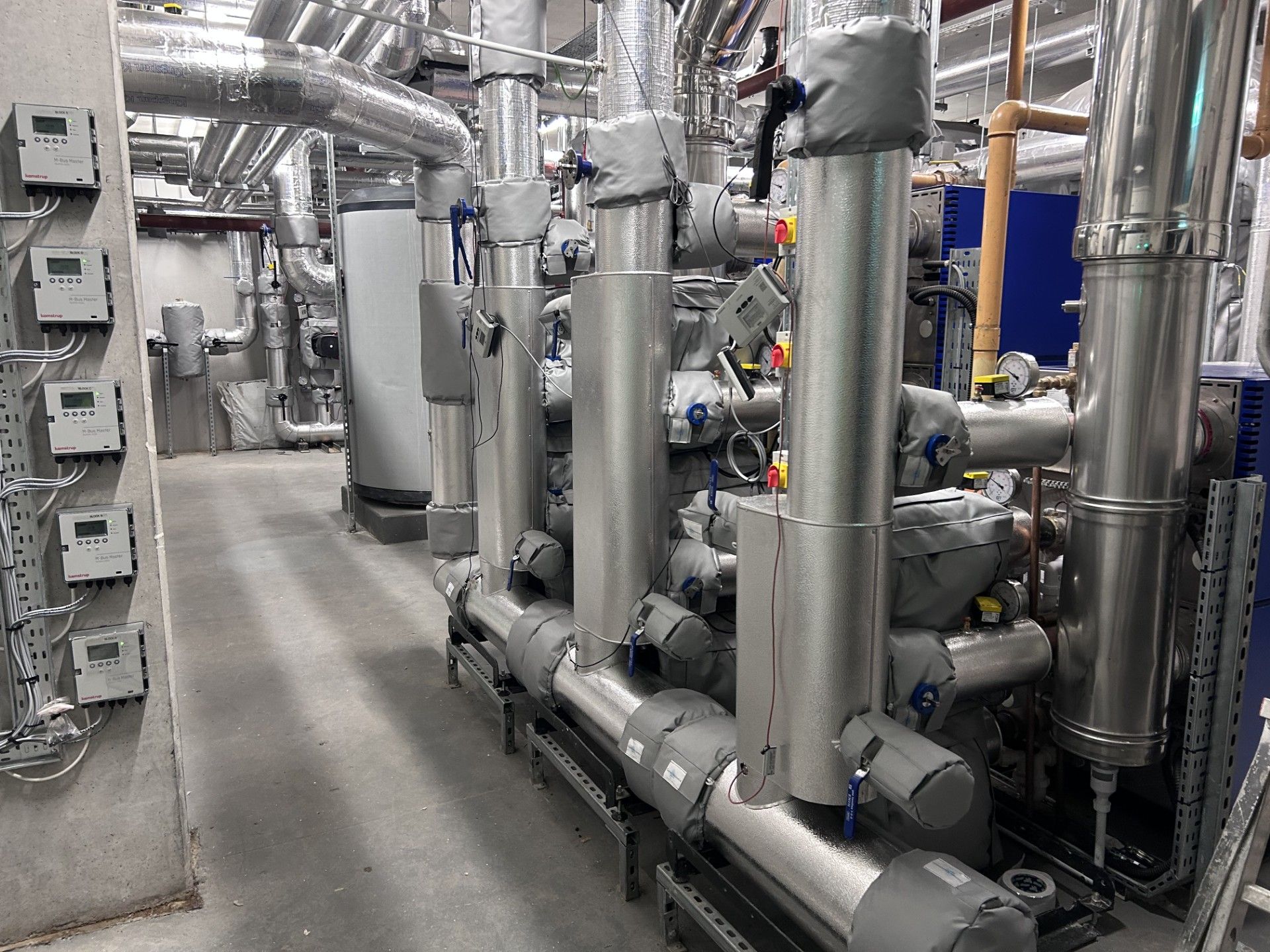 Boiler house pipework with aluminium cladding fitted to protect the 50 millimeter phenolic pipework insulation, valve jackets