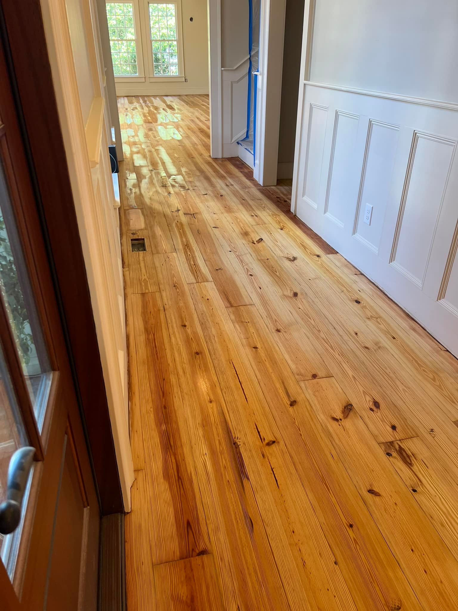 A hallway with hardwood floors in a house.
