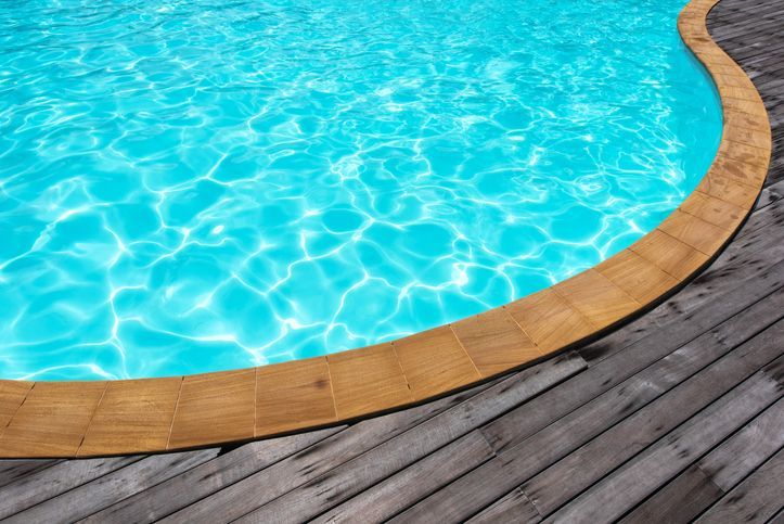 Swimming Pool With Wooden Trim and Deck in Porter, TX
