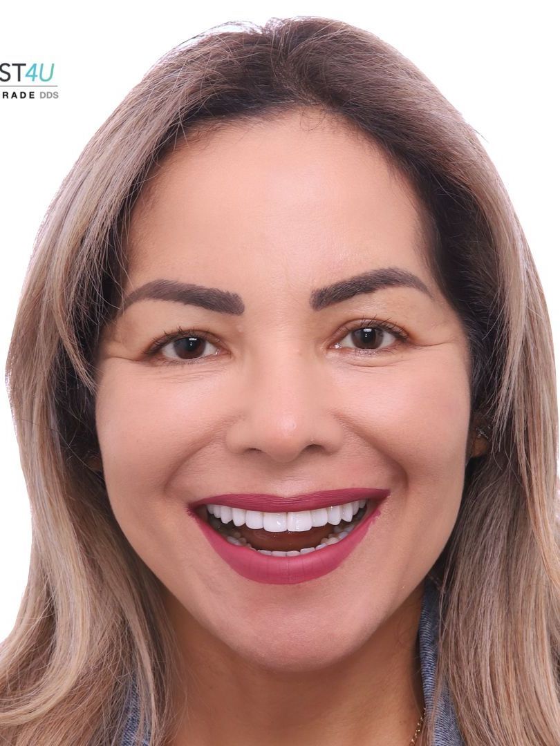 A close up of a woman 's face with a smile on her face.