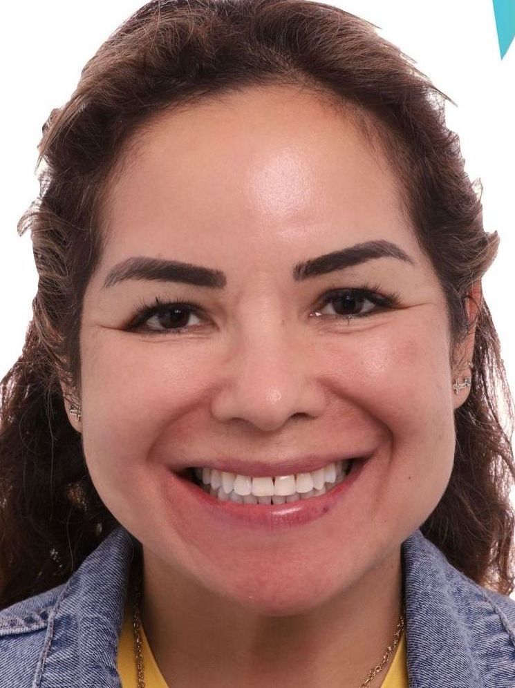 A close up of a woman 's face with a smile on her face