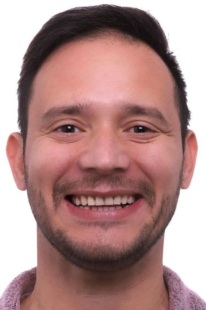 A man with a beard is smiling for the camera.