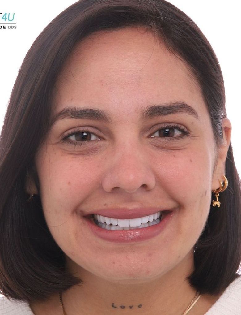 A close up of a woman 's face with the word love on her neck