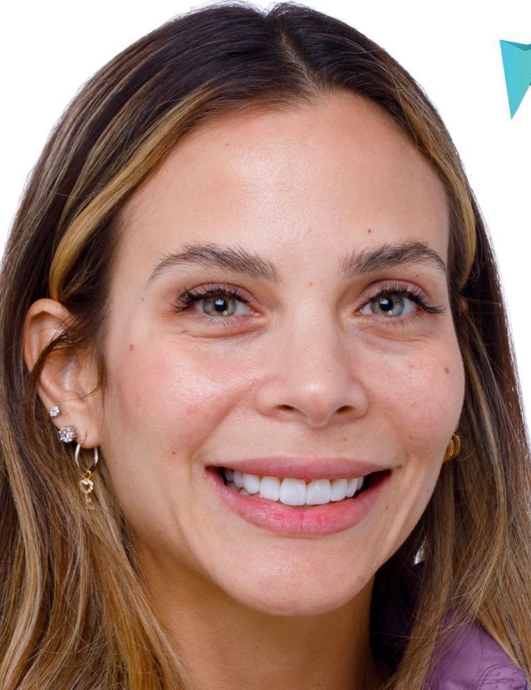A close up of a woman 's face with a smile on her face