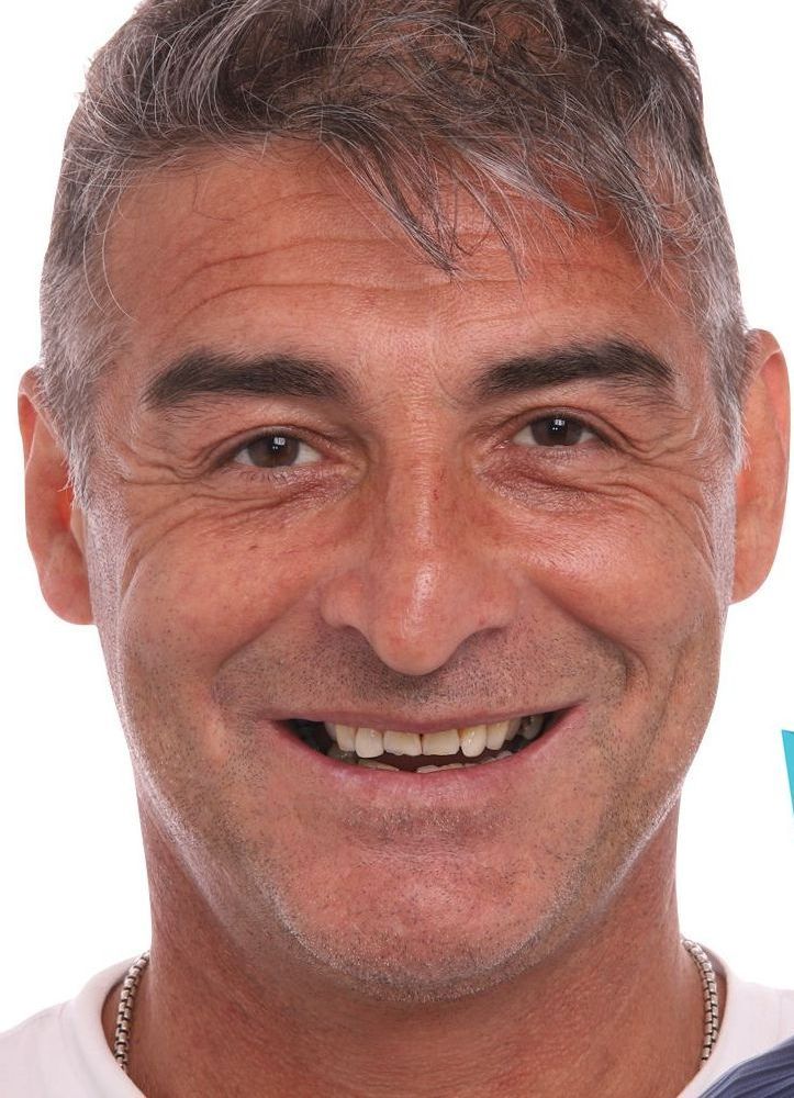 A close up of a man 's face with a smile on his face